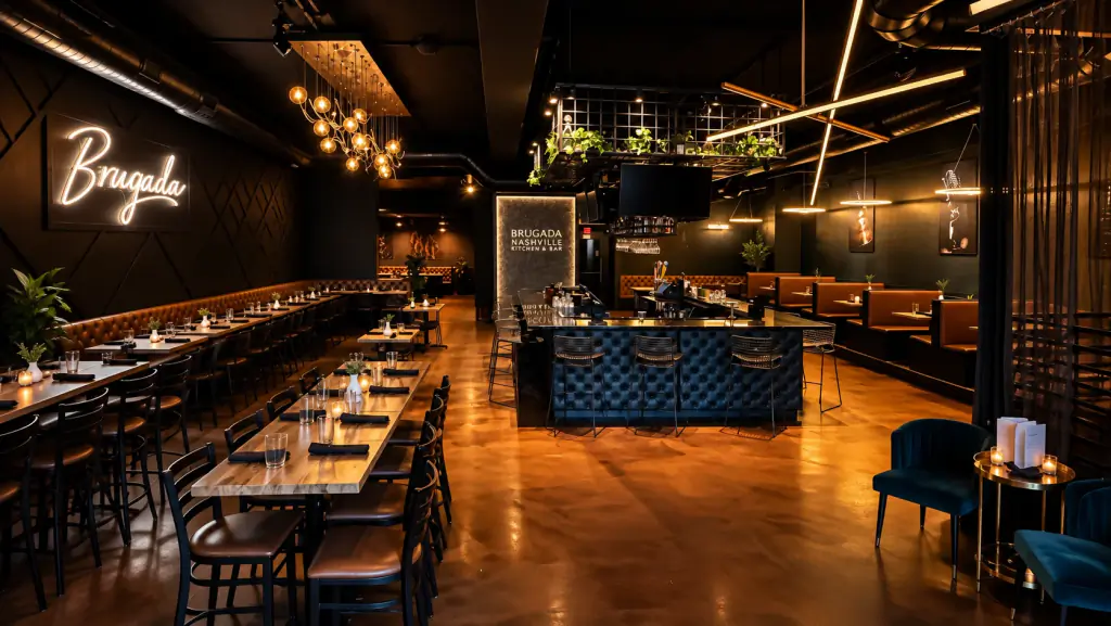 Main dining room at Brugada Kitchen & Bar with the neon Brugada sign, communal tables and the bar