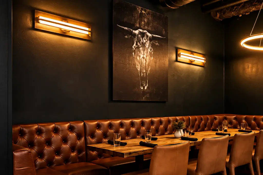 Longhorn skull print above the tufted leather banquette in the Skulls Nook at Brugada Kitchen & Bar
